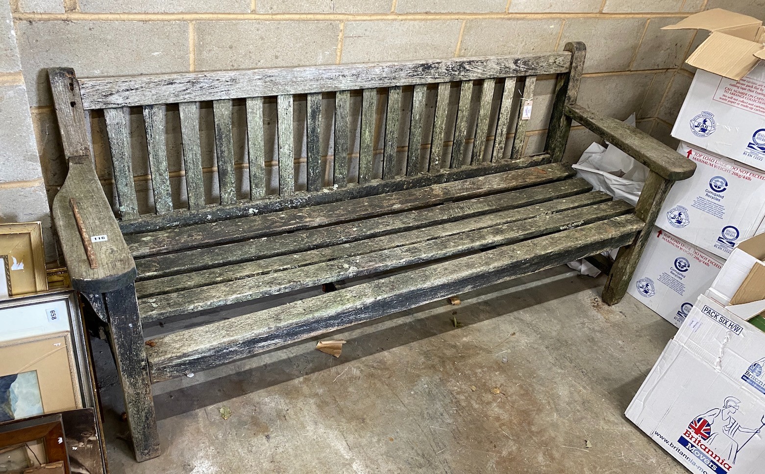 A weathered teak garden bench, length 194cm, height 83cm (a.f.)
